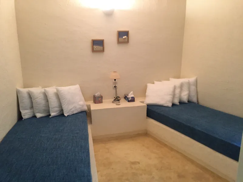 Double bedroom with wrought-iron bed frame and whitewashed walls
