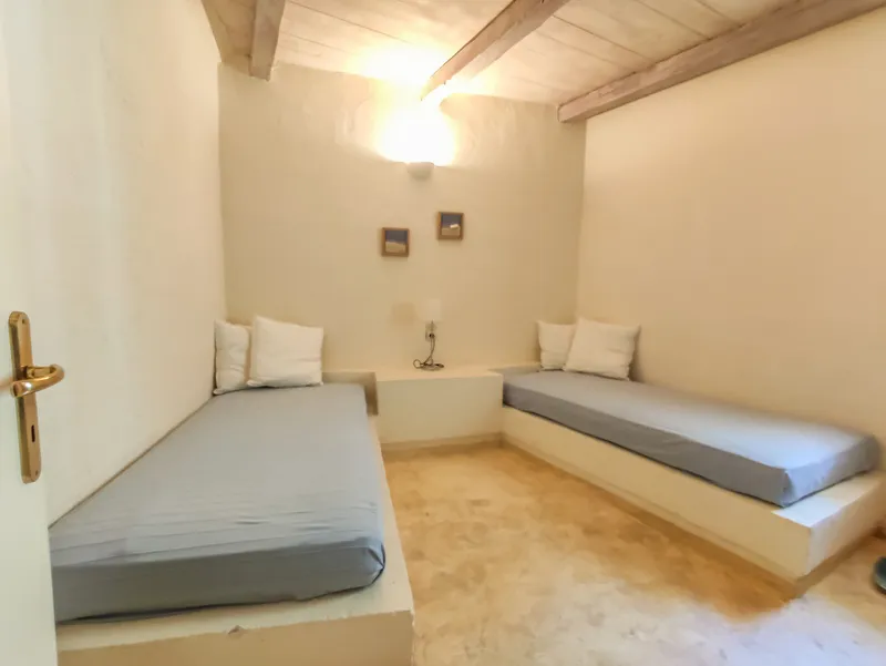 Double bedroom with garden-facing window and bedside lighting