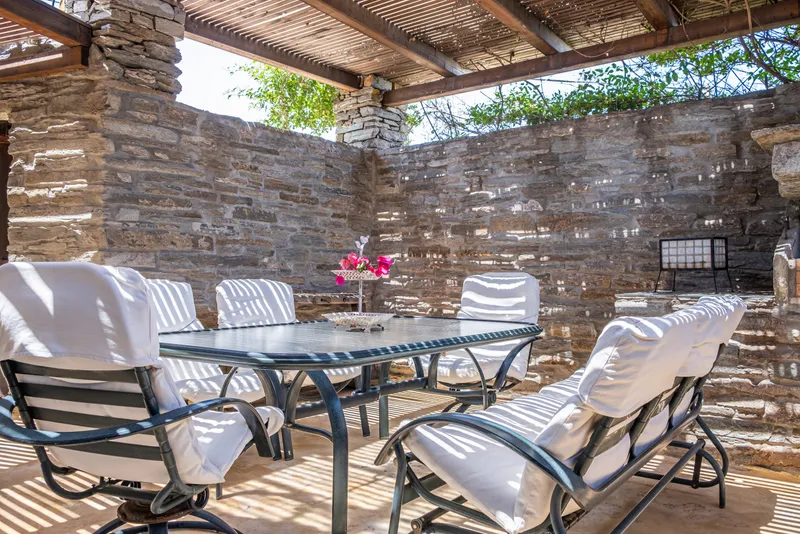Shaded courtyard dining area adjacent to the barbecue station