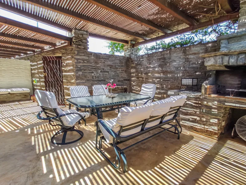 Outdoor dining table in the courtyard with pergola overhead