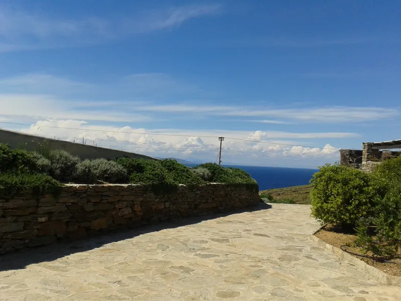 Stone villa facade seen from the entrance gate