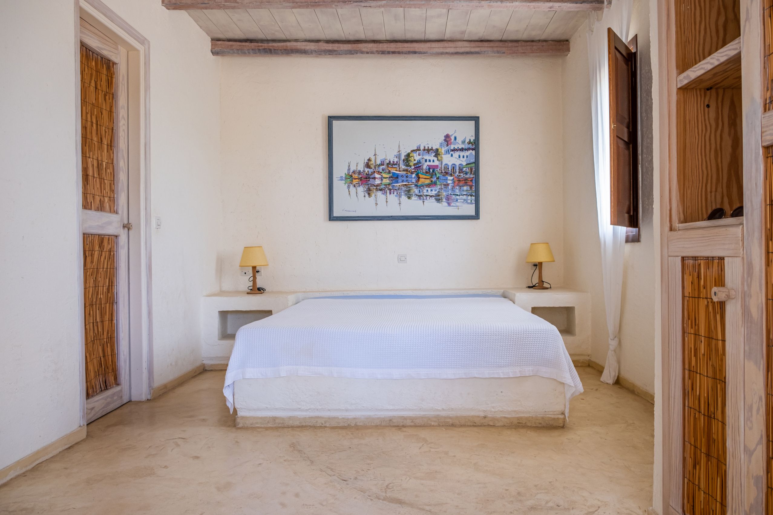 Master bedroom with double bed and stone feature wall