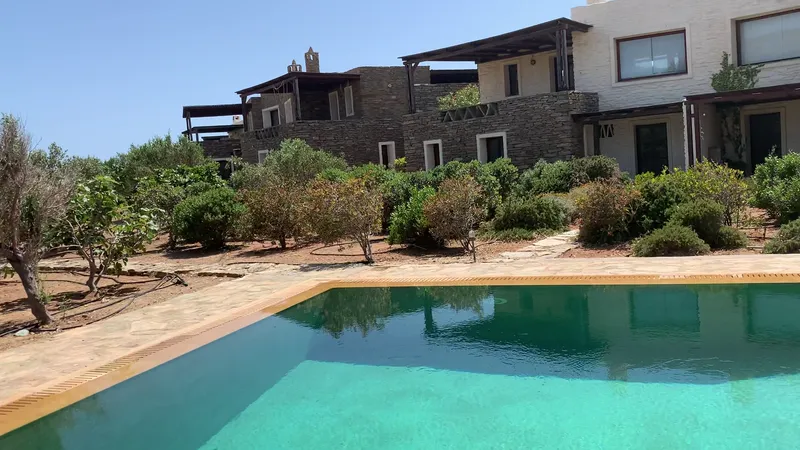 Evening pool with ambient lighting and garden backdrop