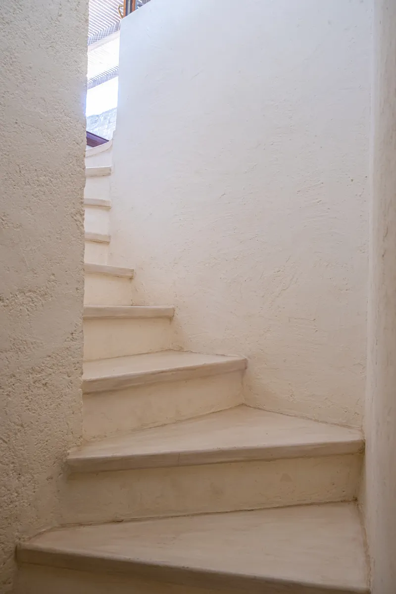 Stone steps connecting the pool terrace to the lower garden level